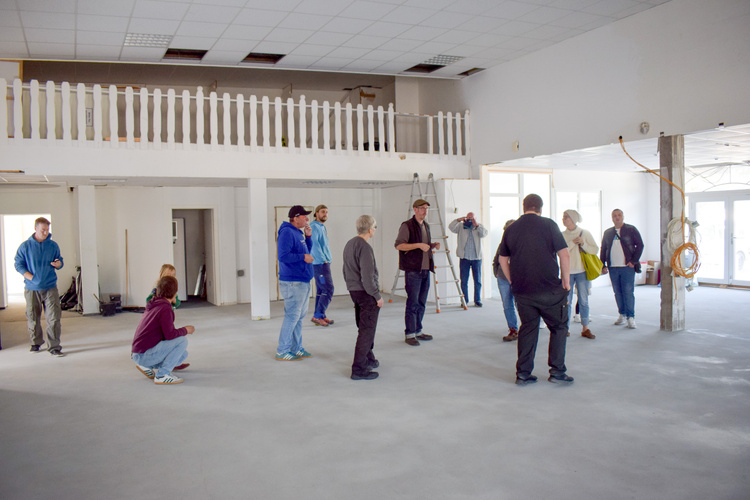 Mehrere Mitarbeitende in der neuen noch leeren Halle