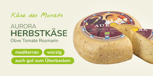 KI-generierte Beschreibung: Hauptinhalt: Käse des Monats "Aurora Herbstkäse" mit Oliven, Tomaten und Rosmarin. Text: "Käse des Monats AURORA HERBSTKÄSE Olive Tomate Rosmarin mediterran würzig auch gut zum Überbacken".